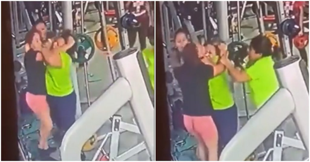 Two women fight over gym equipment
